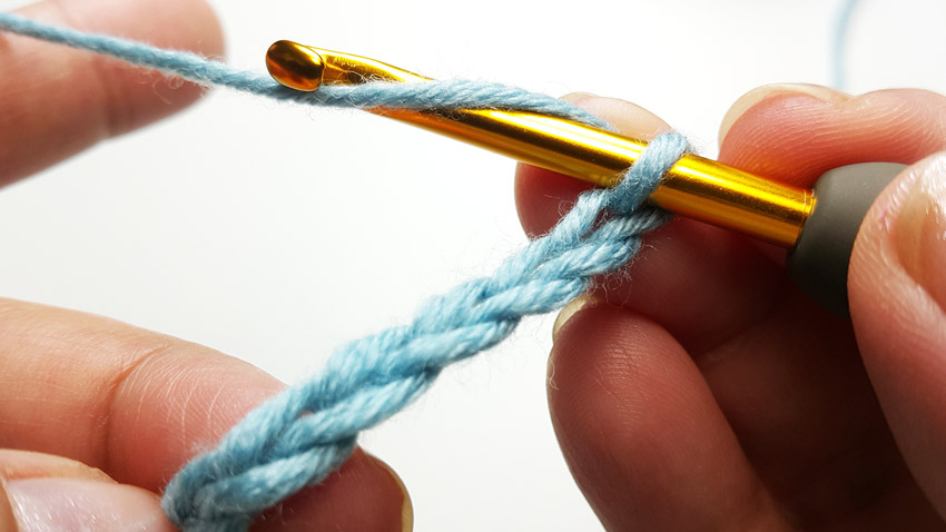 Holding a crochet slipknot