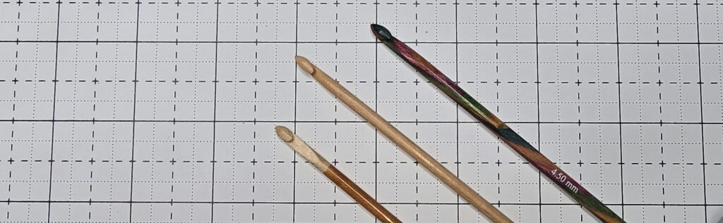 Elizabeth is showing you crochet hooks can be made of other wooden materials other than bamboos