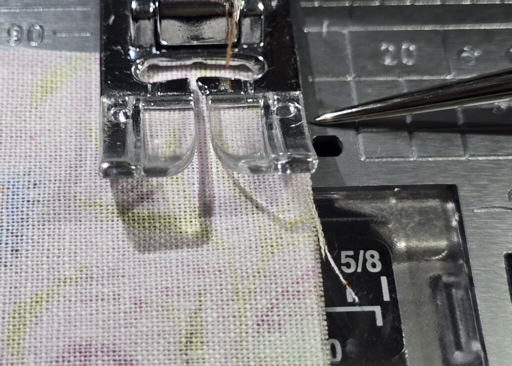 Beth is showing fabric placement against Janome standard foot and straight stitch plate to sew the quarter inch allowance on sttich number 7